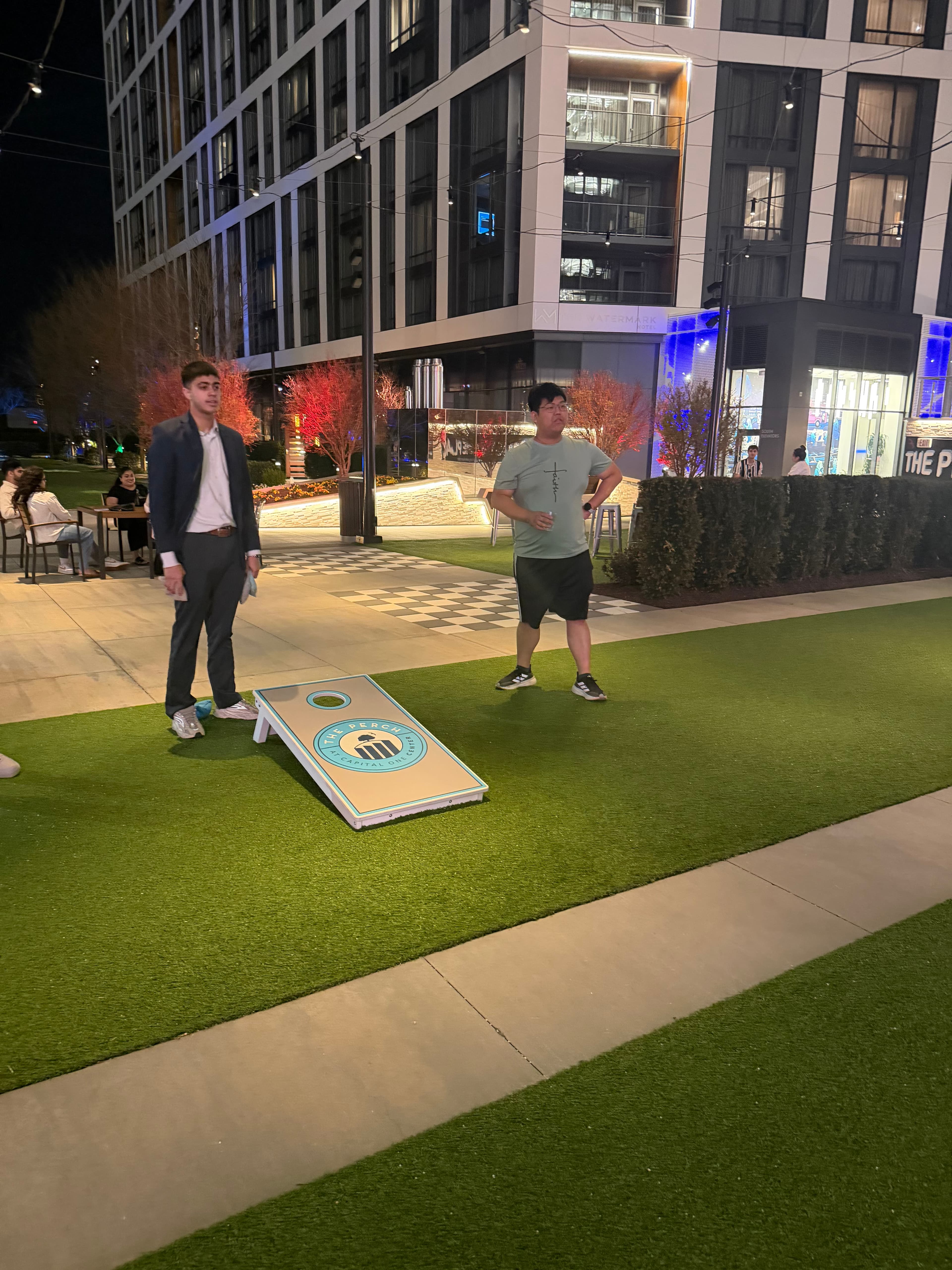 Team members playing cornhole during a team night