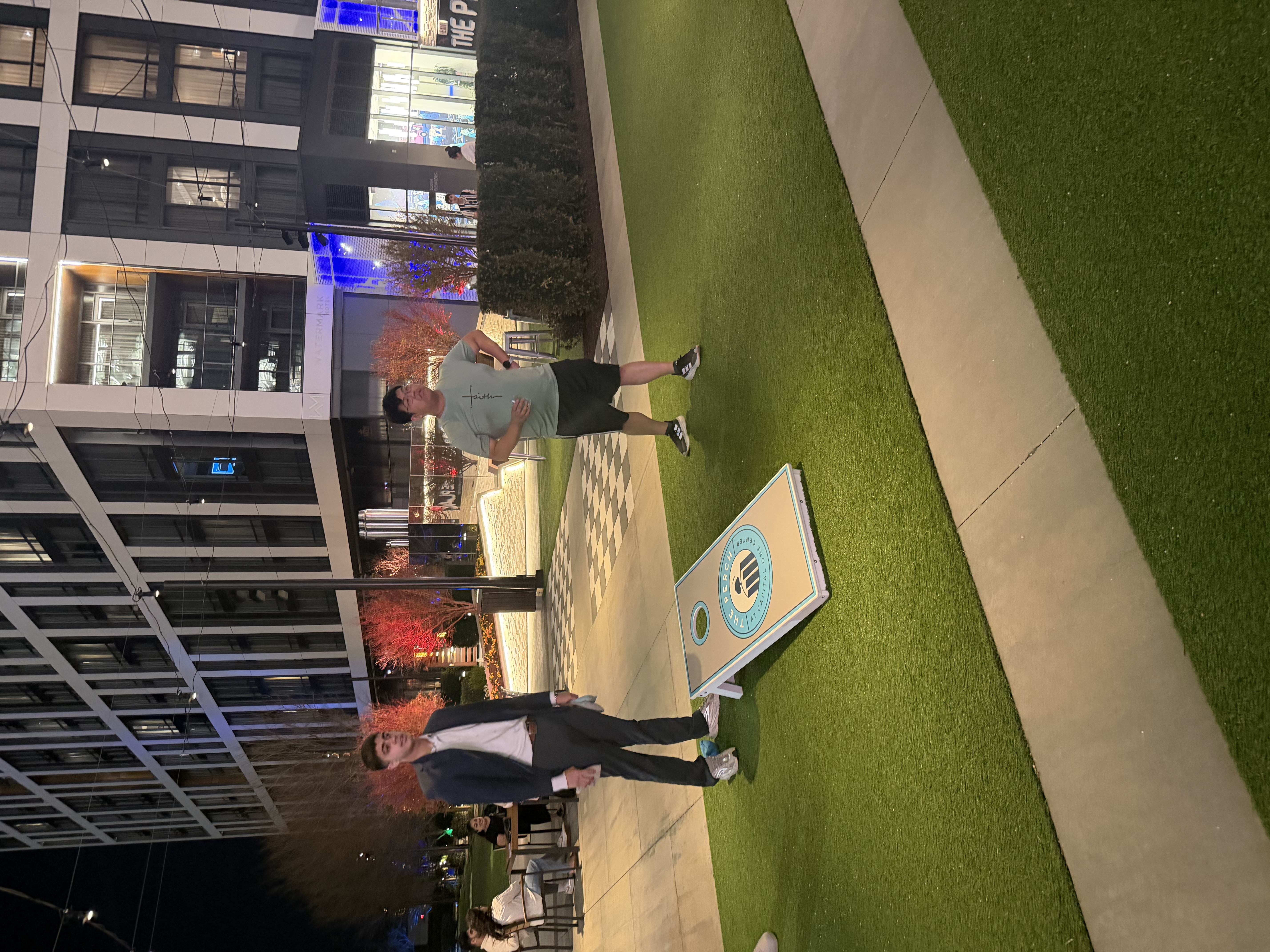 Team members playing cornhole during a team night